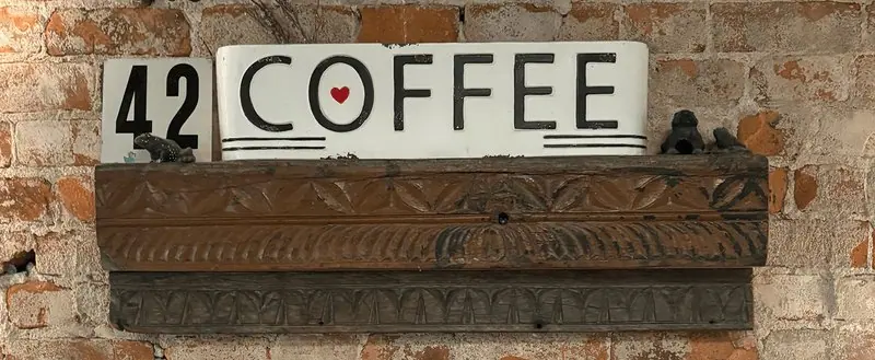 42 Coffee letter board sign on the brick wall inside the shop