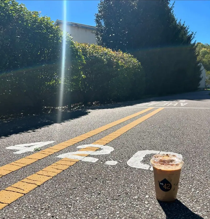 The painted 42.0 mile marker on the Little Miami Scenic Trail with a Mile 42 iced coffee